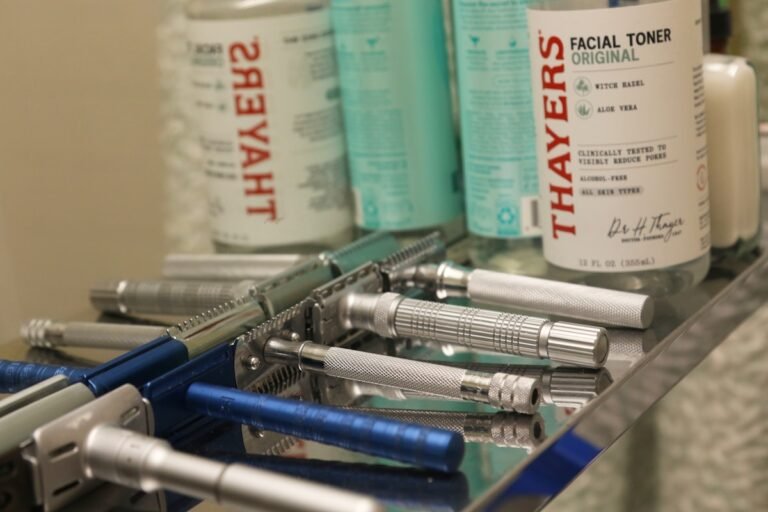 Collection of vintage safety razors and facial toner bottles