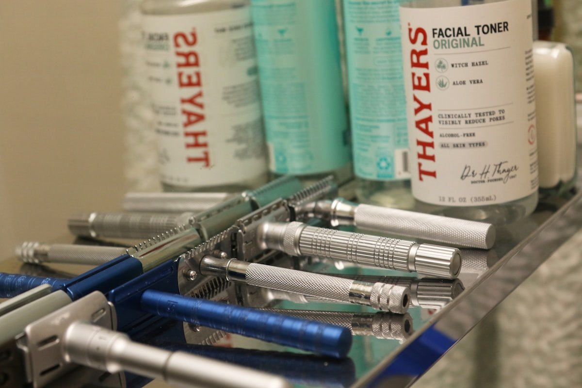 Collection of vintage safety razors and facial toner bottles