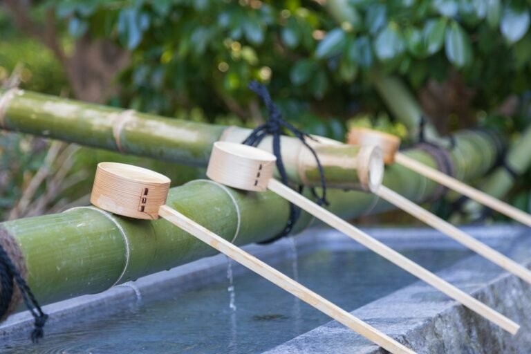 Several bamboo ladles rest on a bamboo pole